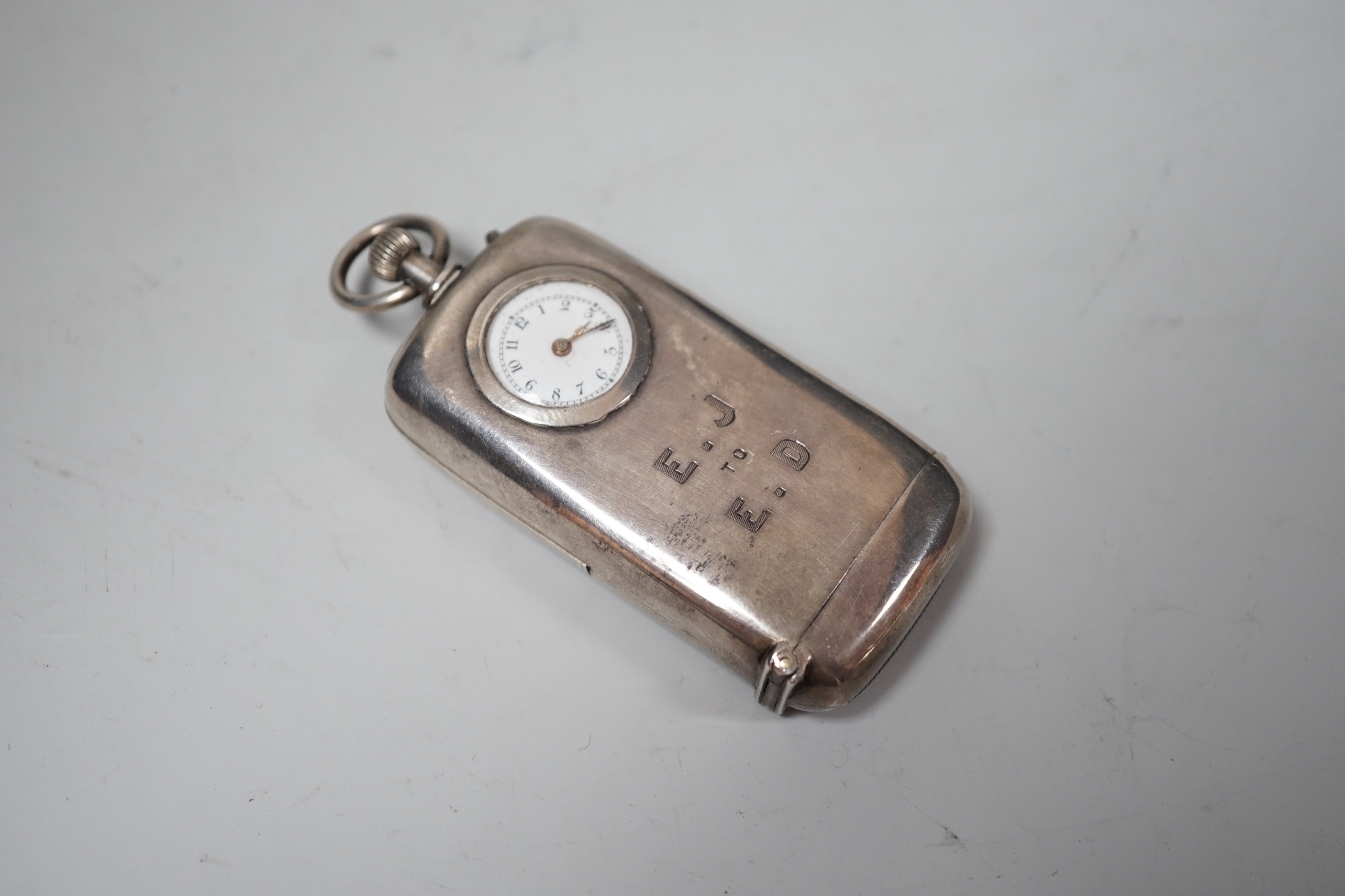 A late Victorian silver combination vesta and sovereign case with inset timepiece, William Neale & Son, Chester, 1887, 75mm.